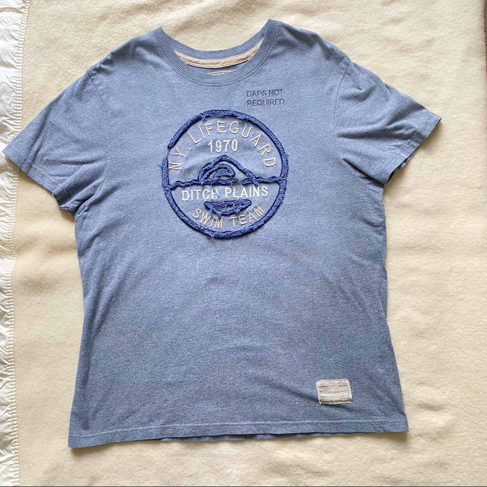 Men’s grey short sleeve tee with blue and white embroidered lifeguard graphic